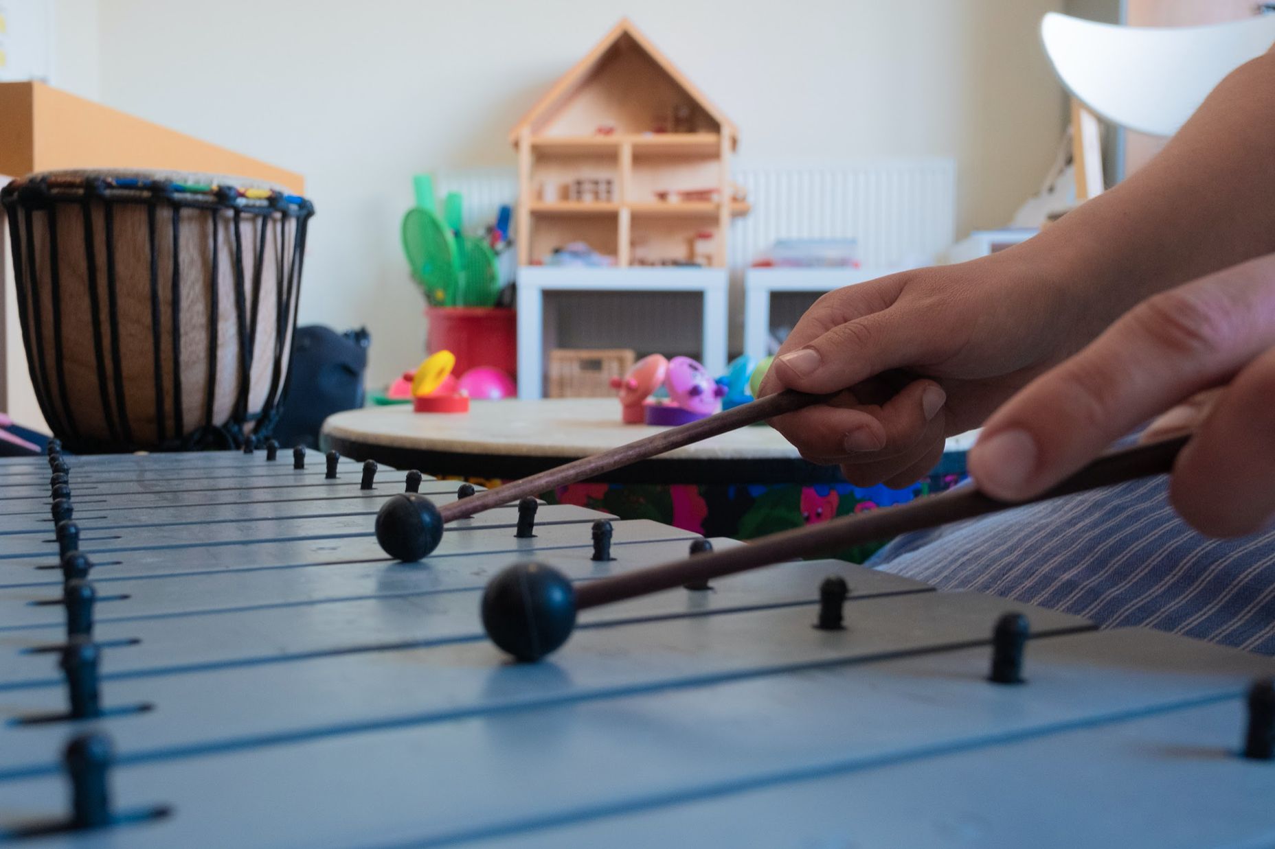 Close-up photo of someone's hands playing a glockenspiel